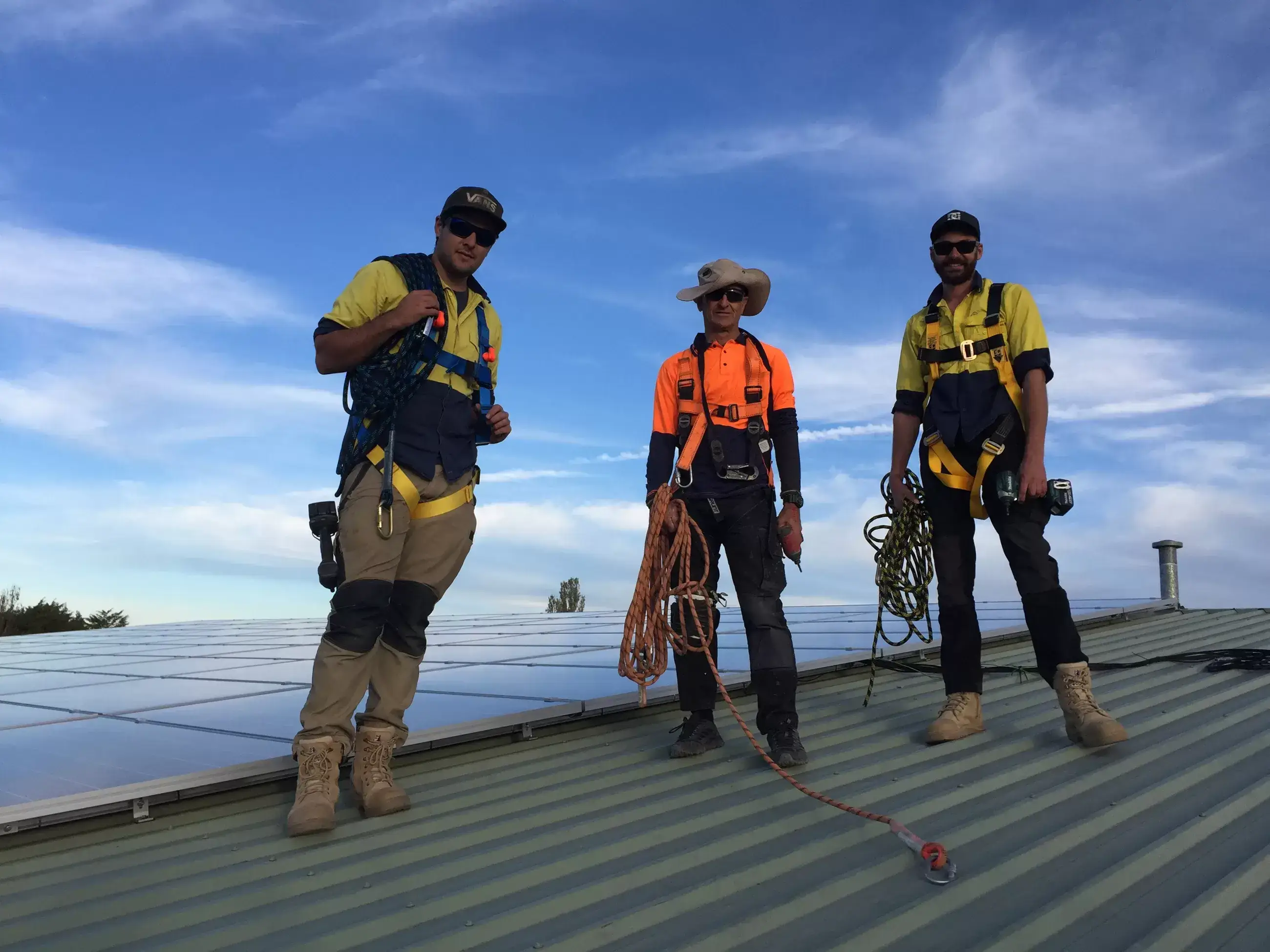 Solar engineers reviewing efficiency data on tablet - Trihita Energy